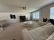 A spacious living room featuring a ceiling fan, plentiful seating and natural light at 1016 Laggan Ln, Indian Trail, NC 28079