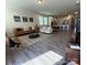 Spacious living room with modern gray flooring, a kitchen view, and stylish décor at 1016 Laggan Ln, Indian Trail, NC 28079