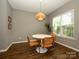Cozy dining room featuring a round table, stylish chairs, modern light fixture, and natural light at 10639 Secret Garden Ln, Charlotte, NC 28214