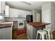 Charming kitchen with white cabinetry, modern appliances, and a stylish butcher block island at 10639 Secret Garden Ln, Charlotte, NC 28214