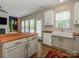 Bright kitchen featuring stainless steel appliances, a large sink, and a butcher block island countertop at 10639 Secret Garden Ln, Charlotte, NC 28214