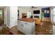Open-concept living room with a fireplace, hardwood floors, and a butcher block kitchen island at 10639 Secret Garden Ln, Charlotte, NC 28214