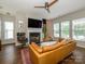 Comfortable living room featuring a fireplace, plush seating, hardwood floors, and ample natural light at 10639 Secret Garden Ln, Charlotte, NC 28214