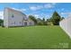 Large fenced backyard, plenty of grass, and a view of the back side of the house at 1111 Balcorn Pl, Charlotte, NC 28214