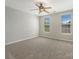 Spacious bedroom with neutral paint, carpet, a ceiling fan and two windows at 1111 Balcorn Pl, Charlotte, NC 28214