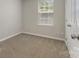 Bedroom has carpet, a double door closet, a window, and neutral colored walls at 1111 Balcorn Pl, Charlotte, NC 28214