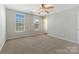 Bright bedroom with neutral paint, carpet, a ceiling fan and two windows at 1111 Balcorn Pl, Charlotte, NC 28214