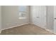 Bedroom featuring neutral paint, carpet, a window with blinds, and double door closet at 1111 Balcorn Pl, Charlotte, NC 28214