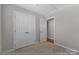Bedroom with neutral paint, carpet, closet with double doors, and a doorway to the hall at 1111 Balcorn Pl, Charlotte, NC 28214