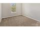 Cozy bedroom with neutral walls, carpet flooring, and a bright window at 1111 Balcorn Pl, Charlotte, NC 28214