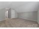Bonus room with neutral colored walls, carpet, and an access door to the attic at 1111 Balcorn Pl, Charlotte, NC 28214
