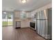 Updated kitchen with stainless steel appliances, white cabinets, and a view to the backyard at 1111 Balcorn Pl, Charlotte, NC 28214
