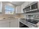 Bright kitchen featuring stainless steel appliances, white cabinets, and natural light at 1111 Balcorn Pl, Charlotte, NC 28214