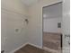 Convenient laundry room with sleek flooring and a view to the garage at 1111 Balcorn Pl, Charlotte, NC 28214