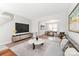 Bright, open-concept living room featuring modern decor and a seamless transition to the dining area at 1111 Balcorn Pl, Charlotte, NC 28214