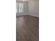Bright living room featuring hardwood floors and natural light from the window at 1111 Balcorn Pl, Charlotte, NC 28214