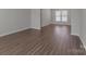 Open living area features hardwood floors, neutral colors, and natural light at 1111 Balcorn Pl, Charlotte, NC 28214