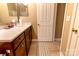 Well-lit bathroom featuring a white countertop and wooden vanity at 11867 Ridgeway Park Dr, Charlotte, NC 28277