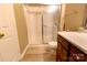 Well-lit bathroom featuring a glass door shower and wooden vanity at 11867 Ridgeway Park Dr, Charlotte, NC 28277