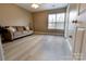 Comfortable bedroom with ample natural light, wood-look floors, and a relaxing seating area at 11867 Ridgeway Park Dr, Charlotte, NC 28277