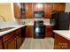 Stylish kitchen with dark cabinetry, black appliances, and light countertops, creating a modern aesthetic at 11867 Ridgeway Park Dr, Charlotte, NC 28277