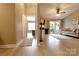 Spacious living room with wood-look floors, neutral walls, ceiling fan, and access to an outdoor area at 11867 Ridgeway Park Dr, Charlotte, NC 28277
