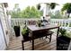 Outdoor porch, perfect for relaxing, with table, bench and assorted potted plants at 11867 Ridgeway Park Dr, Charlotte, NC 28277