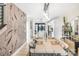 Modern dining room with a long table, pendant lights, and stylish decor, leading into the kitchen at 121 Verbena Ne St # 14, Charlotte, NC 28217