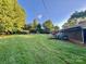 Expansive backyard with lush greenery, storage shed and ample space for outdoor activities at 1229 Rocky Face Church Rd, Taylorsville, NC 28681