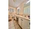 Neutral bathroom features double sinks, large mirrors, and tiled flooring at 1229 Rocky Face Church Rd, Taylorsville, NC 28681