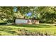 Quaint brick home on a large lot, shaded by mature trees and green grass at 1229 Rocky Face Church Rd, Taylorsville, NC 28681