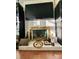 White brick fireplace with a gold framed firebox, decor, and mounted television at 1229 Rocky Face Church Rd, Taylorsville, NC 28681