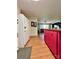 Spacious kitchen with stainless steel refrigerator, red cabinets, and an open layout to living area at 1229 Rocky Face Church Rd, Taylorsville, NC 28681