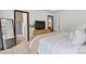 Modern bedroom with a view of the ensuite bathroom, a cozy seating area, and a neutral color scheme at 139 Batten Ridge Dr, Statesville, NC 28677