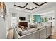 A living room with a coffered ceiling, open to the kitchen area, and a wall of windows at 139 Batten Ridge Dr, Statesville, NC 28677