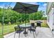 Outdoor patio featuring a dining set, umbrella, string lights, and grill at 139 Batten Ridge Dr, Statesville, NC 28677