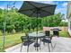 Outdoor patio featuring a dining set, umbrella, string lights, and grill at 139 Batten Ridge Dr, Statesville, NC 28677