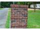 Close-up of a brick address marker displaying the silver numbers '1435' at 14335 Saint Johns Dr # 83, Stanfield, NC 28163