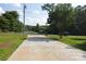 Long, paved driveway leading to a home with mature trees in a peaceful, verdant neighborhood at 14335 Saint Johns Dr # 83, Stanfield, NC 28163