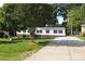 Charming home with a long concrete driveway and lush green lawn at 14335 Saint Johns Dr # 83, Stanfield, NC 28163