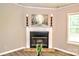 Traditional fireplace with mantle surrounded by picture frames and art at 14335 Saint Johns Dr # 83, Stanfield, NC 28163