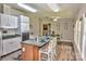 Open kitchen features wood floors, an island with seating, and white cabinets at 14335 Saint Johns Dr # 83, Stanfield, NC 28163