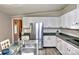 Efficient kitchen with white cabinetry, stainless steel appliances, and ample countertop space at 14335 Saint Johns Dr # 83, Stanfield, NC 28163