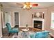 This living room features a fireplace, ceiling fan, and cozy seating at 14335 Saint Johns Dr # 83, Stanfield, NC 28163