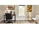 Bright home office features a work desk with art accents and natural light from the window at 14335 Saint Johns Dr # 83, Stanfield, NC 28163