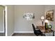 Home office with grey and brown tones includes a work desk and modern city art at 14335 Saint Johns Dr # 83, Stanfield, NC 28163