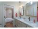 Bathroom featuring a dual sink vanity and framed mirrors with views to tub/shower at 16132 Mclester Rd, Oakboro, NC 28129