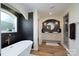 Elegant bathroom featuring a soaking tub, double sinks, walk-in shower, and designer lighting and fixtures at 16132 Mclester Rd, Oakboro, NC 28129