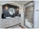 Elegant bathroom with double sinks, a decorative mirror, modern lighting, and a glass-enclosed shower at 16132 Mclester Rd, Oakboro, NC 28129
