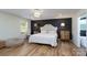 Bedroom with a decorative chandelier, neutral walls, hardwood floors, and ample natural light from a window at 16132 Mclester Rd, Oakboro, NC 28129